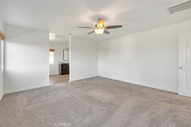 carpeted empty room with ceiling fan