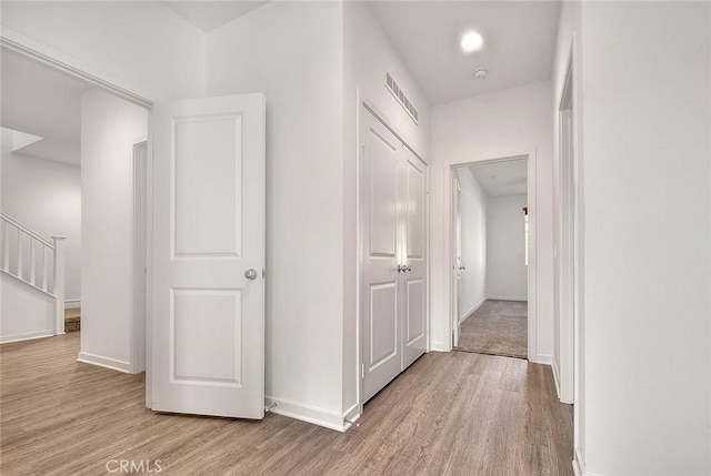 corridor with light hardwood / wood-style floors