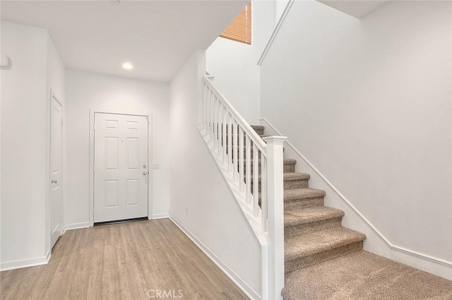 staircase featuring wood-type flooring