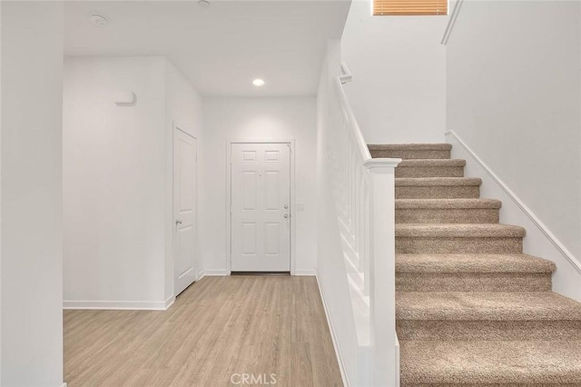 stairway featuring hardwood / wood-style floors