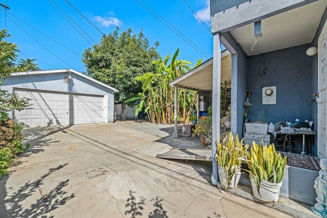 view of patio / terrace featuring a garage and an outdoor structure