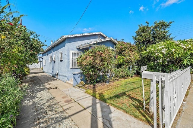 view of side of home featuring a yard