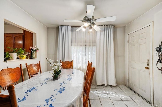 tiled dining room with ceiling fan