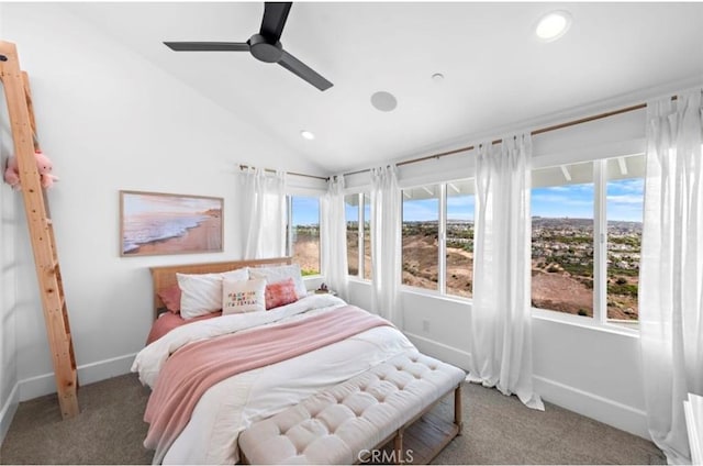 carpeted bedroom featuring multiple windows, lofted ceiling, and ceiling fan