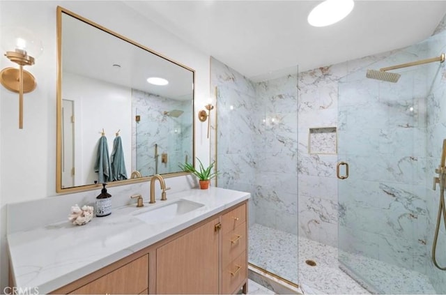 bathroom with vanity and a shower with shower door