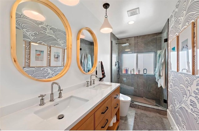 bathroom featuring vanity, a shower with shower door, tile patterned floors, and toilet