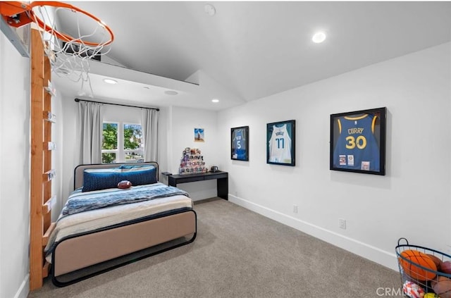 carpeted bedroom with lofted ceiling