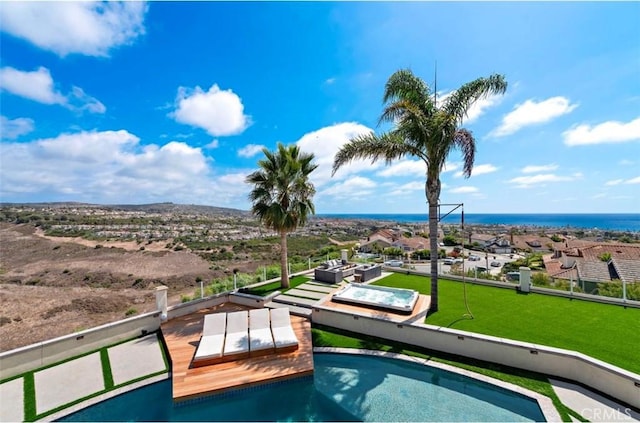 view of pool with a water view