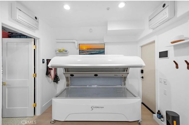 clothes washing area featuring a wall mounted AC