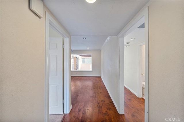 corridor featuring ornamental molding and dark hardwood / wood-style floors