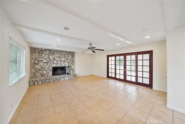 unfurnished living room featuring beamed ceiling, ceiling fan, a fireplace, and light tile patterned flooring