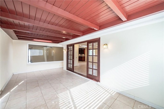 hallway with beamed ceiling, wooden ceiling, tile patterned floors, and french doors