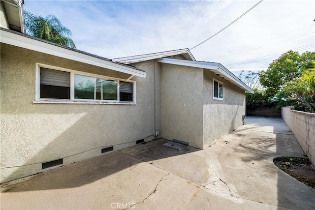 view of side of property with a patio