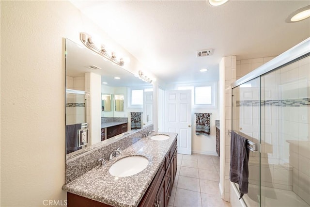 bathroom featuring an enclosed shower, vanity, and tile patterned floors