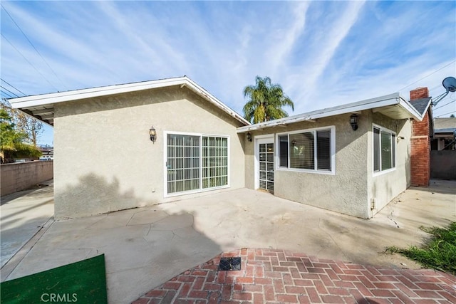 back of property with a patio