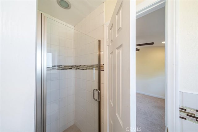 bathroom featuring a shower with shower door