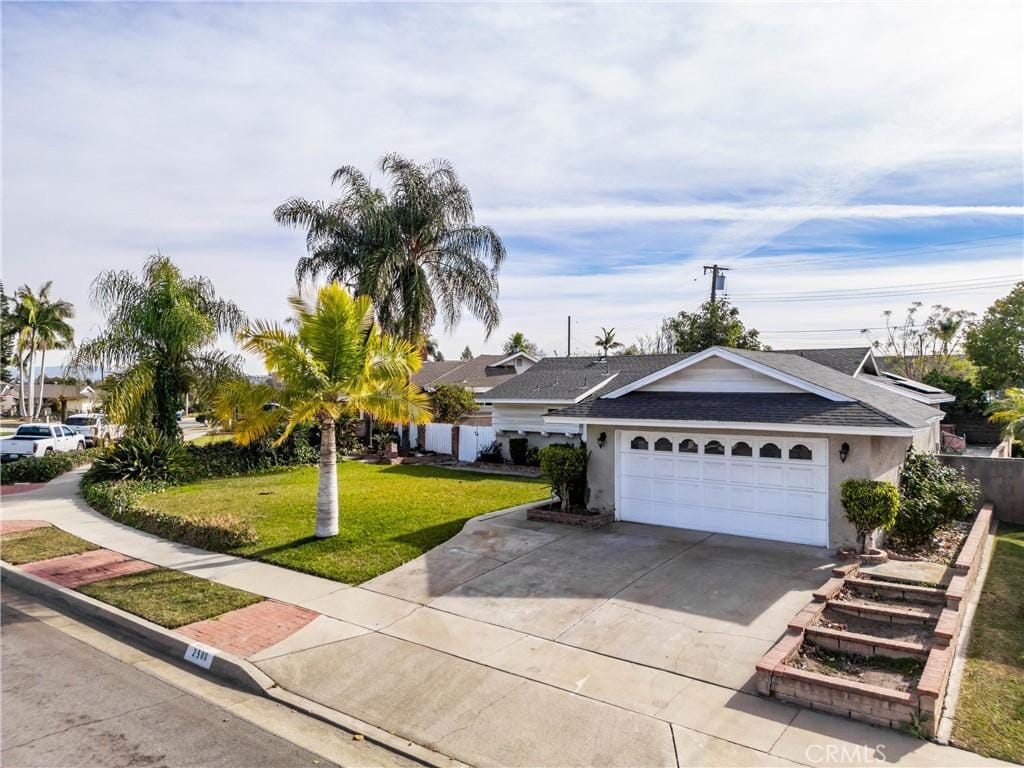 ranch-style home with a garage and a front yard