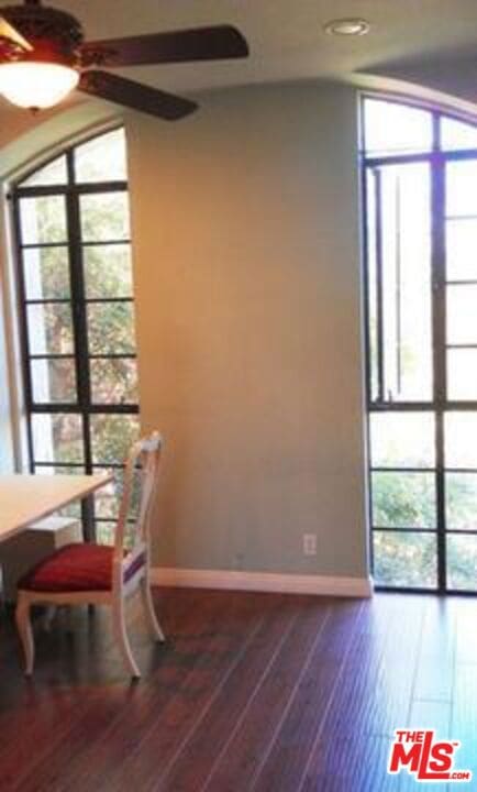 dining space with hardwood / wood-style flooring and ceiling fan