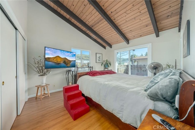 bedroom with beam ceiling, high vaulted ceiling, light hardwood / wood-style floors, wooden ceiling, and a closet