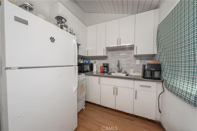 kitchen with sink, white appliances, tasteful backsplash, white cabinets, and light wood-type flooring