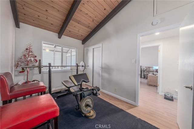 exercise room featuring lofted ceiling, light hardwood / wood-style floors, and wooden ceiling