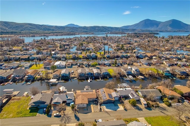 drone / aerial view featuring a water and mountain view