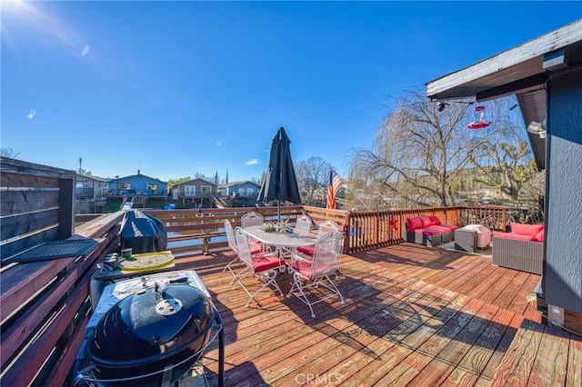 deck with an outdoor living space and a grill