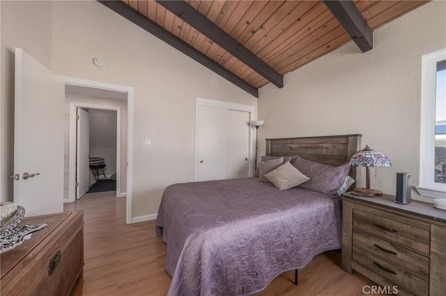 bedroom featuring light hardwood / wood-style flooring, wooden ceiling, and lofted ceiling with beams