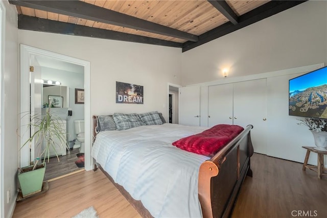 bedroom with hardwood / wood-style flooring, lofted ceiling with beams, wooden ceiling, and ensuite bathroom