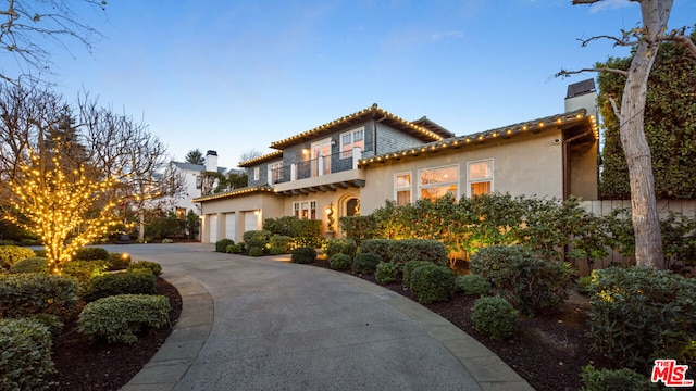 mediterranean / spanish home featuring a garage