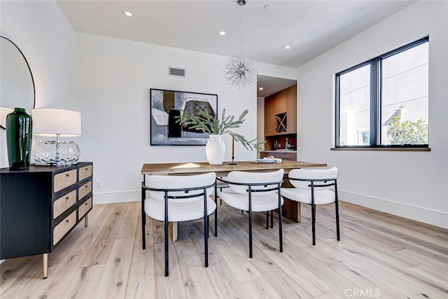 dining area with light hardwood / wood-style floors