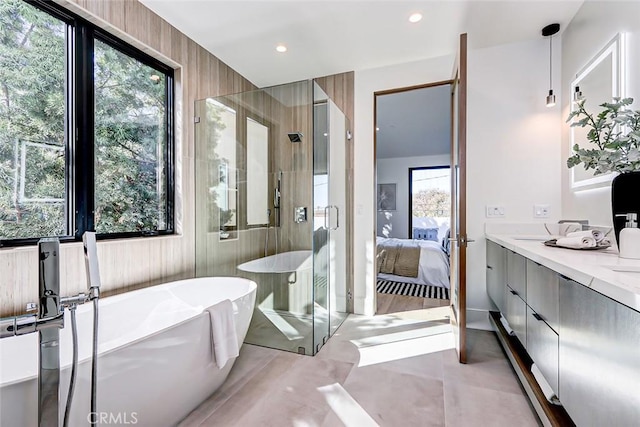 bathroom featuring independent shower and bath and vanity