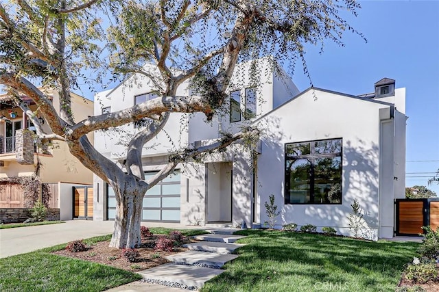 view of front of house featuring a garage and a front lawn