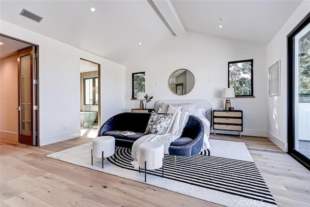 sitting room with lofted ceiling with beams, a healthy amount of sunlight, and light wood-type flooring