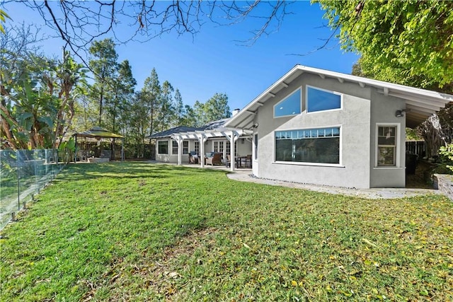 rear view of house with a gazebo, a yard, a patio area, and a pergola