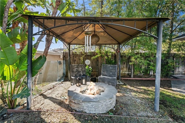 view of patio / terrace with a fire pit and a gazebo