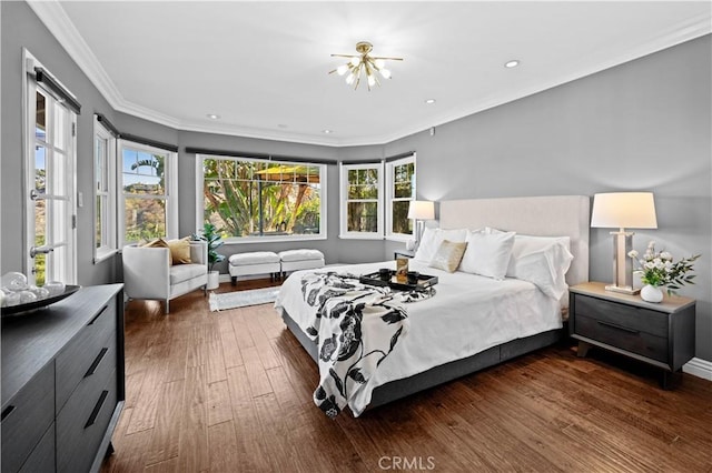 bedroom featuring crown molding, dark hardwood / wood-style flooring, and multiple windows