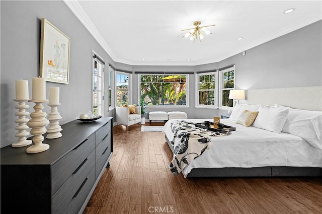 bedroom featuring ornamental molding and dark hardwood / wood-style flooring