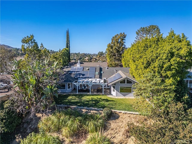 rear view of property featuring a yard