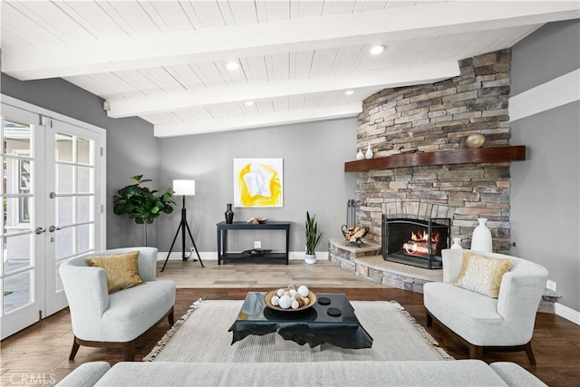 living room with hardwood / wood-style floors, a fireplace, lofted ceiling with beams, plenty of natural light, and french doors