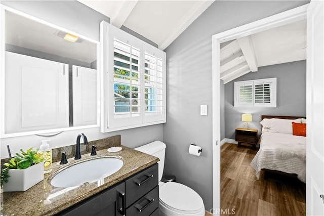 bathroom featuring hardwood / wood-style flooring, vanity, toilet, and lofted ceiling with beams