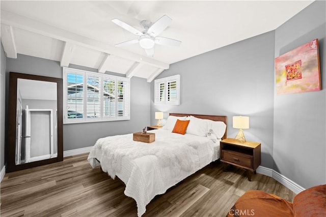 bedroom featuring vaulted ceiling with beams, dark wood-type flooring, and ceiling fan