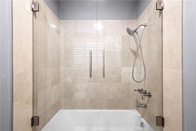 bathroom featuring bath / shower combo with glass door