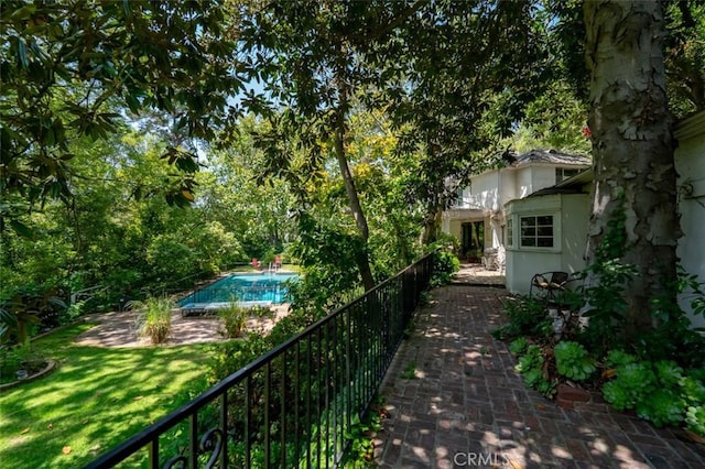 view of pool featuring a lawn