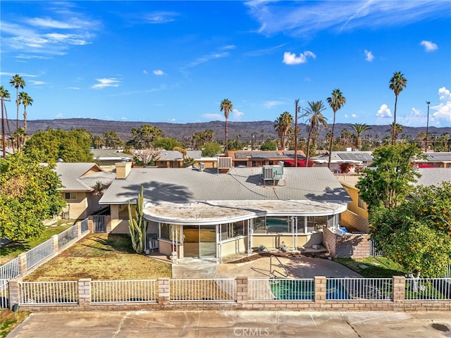 exterior space with a fenced backyard, a patio area, a mountain view, and an outdoor pool