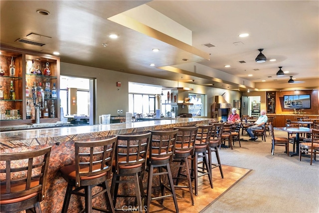 bar with carpet flooring, recessed lighting, visible vents, and a dry bar