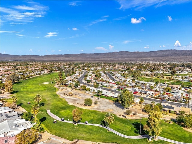 aerial view with golf course view, a residential view, and a mountain view