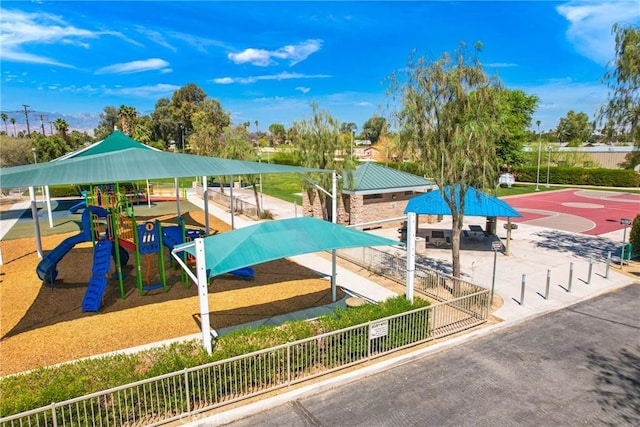 communal playground featuring community basketball court and fence