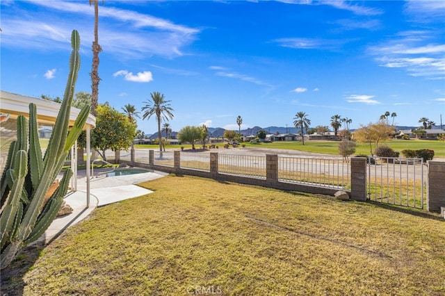 view of yard with a patio, fence, and a residential view
