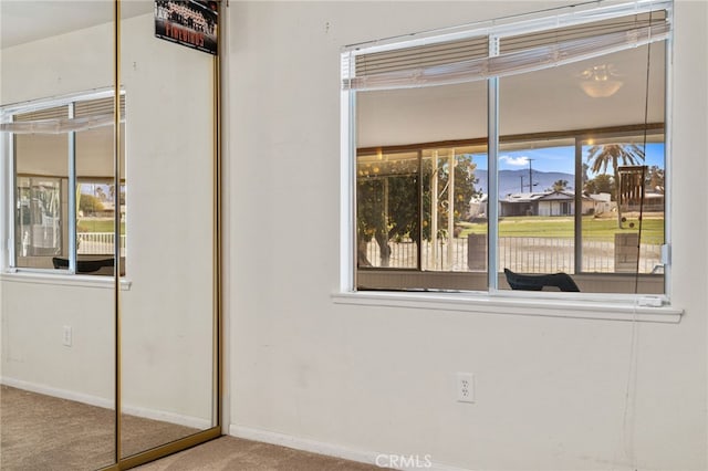 interior space with baseboards and carpet